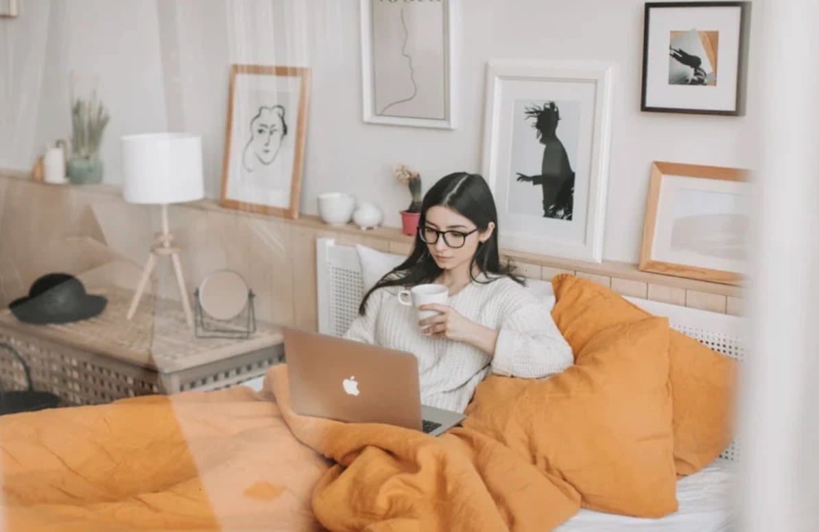 Woman at home with her laptop and tea, settled in for a virtual EMDR intensive session in Florida